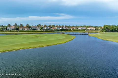 a view of a lake with houses in the back