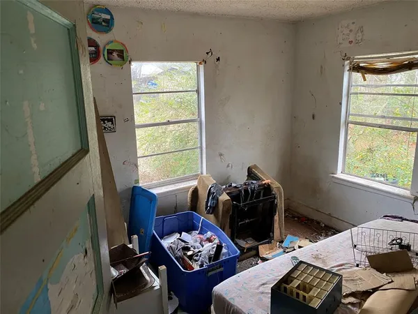 a bedroom with furniture and a window