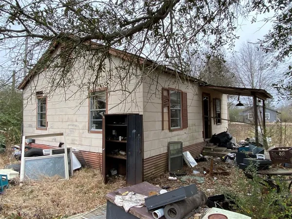 a backyard of a house with barbeque oven table and chairs