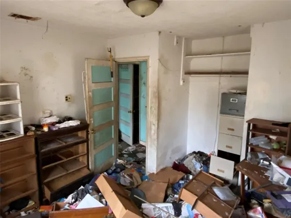 a room with furniture a air conditioner vent and a rug