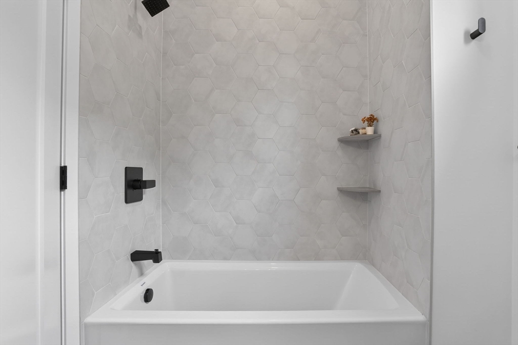 14 Hamlet Street, Unit A Somerville, MA 02143 - Photo 12 of 22 a close up of a bathtub curtain