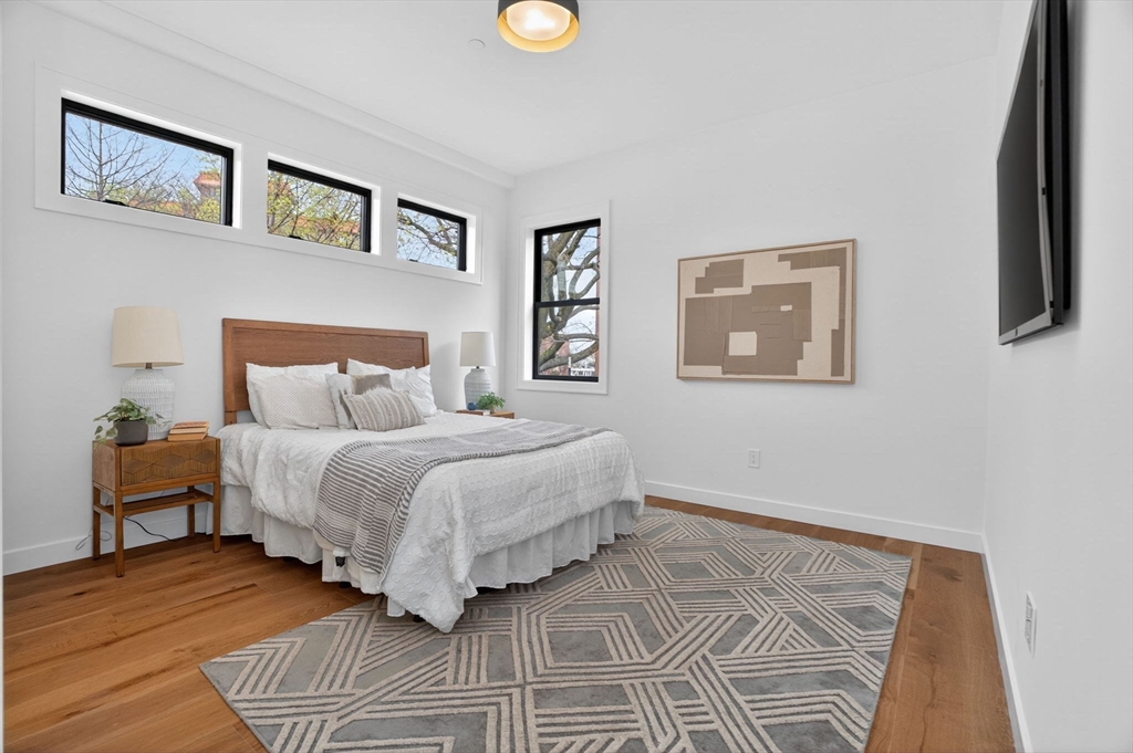 14 Hamlet Street, Unit A Somerville, MA 02143 - Photo 14 of 22 a bedroom with a bed and a lamp on dresser