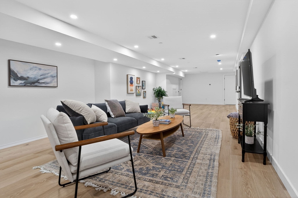 14 Hamlet Street, Unit A Somerville, MA 02143 - Photo 17 of 22 a living room with furniture and a wooden floor
