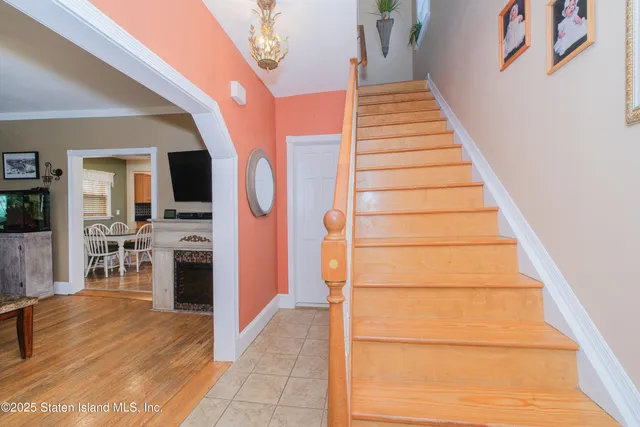 a view of a hallway with wooden floor and a potted plant