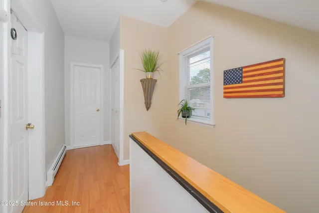 a spacious bedroom with a bed and a chandelier