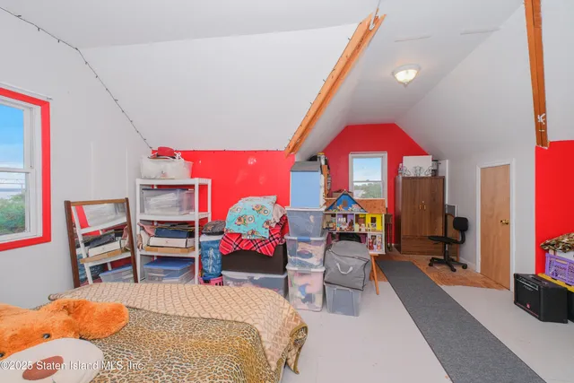 a bedroom with two beds and a window