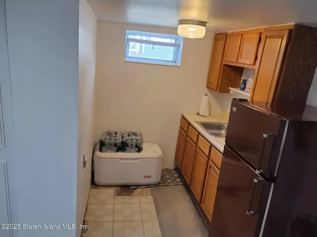 a front view of a house with a yard and potted plants