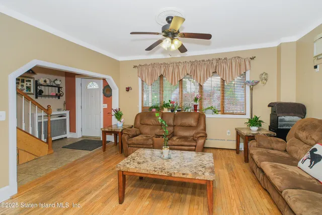 a living room with furniture fireplace and a large window