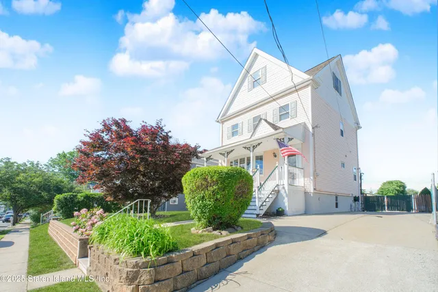 a car parked in front of a house with a patio
