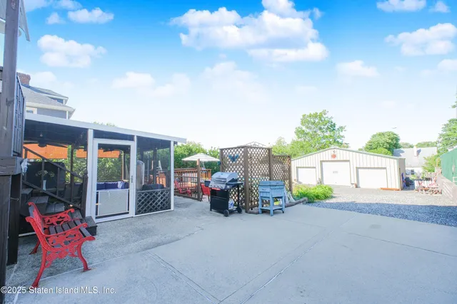 a view of a chairs and table in the back yard of the house