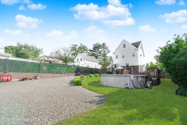 a view of backyard with a garden and entertaining space