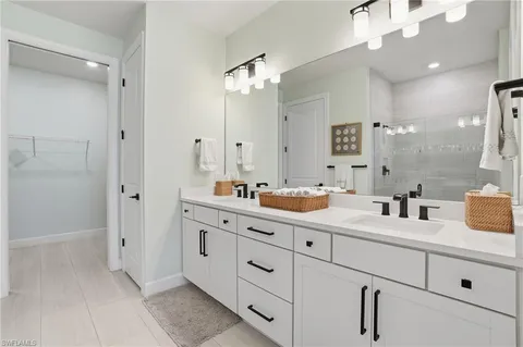a bathroom with a double vanity sink mirror and