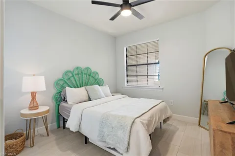 a bedroom with a bed and a chair