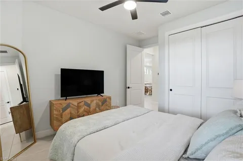 a bedroom with a bed and a flat screen tv