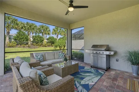 a living room with furniture and a floor to ceiling window