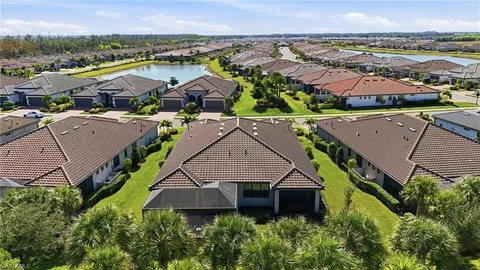 an aerial view of multiple houses with a yard