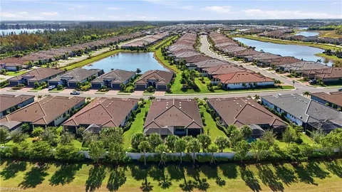 an aerial view of residential houses with outdoor space and lake view