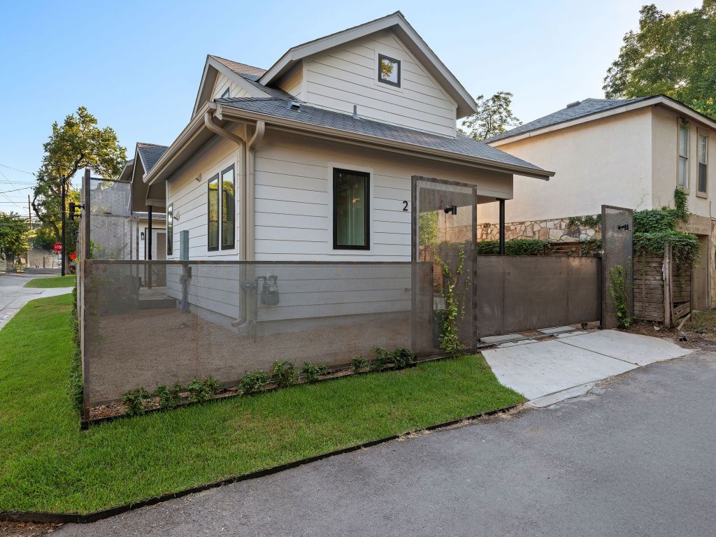 1401 East 3rd Street, Unit 2 Austin, TX 78702 - Photo 26 of 31 Bungalow-style house featuring a shingled roof