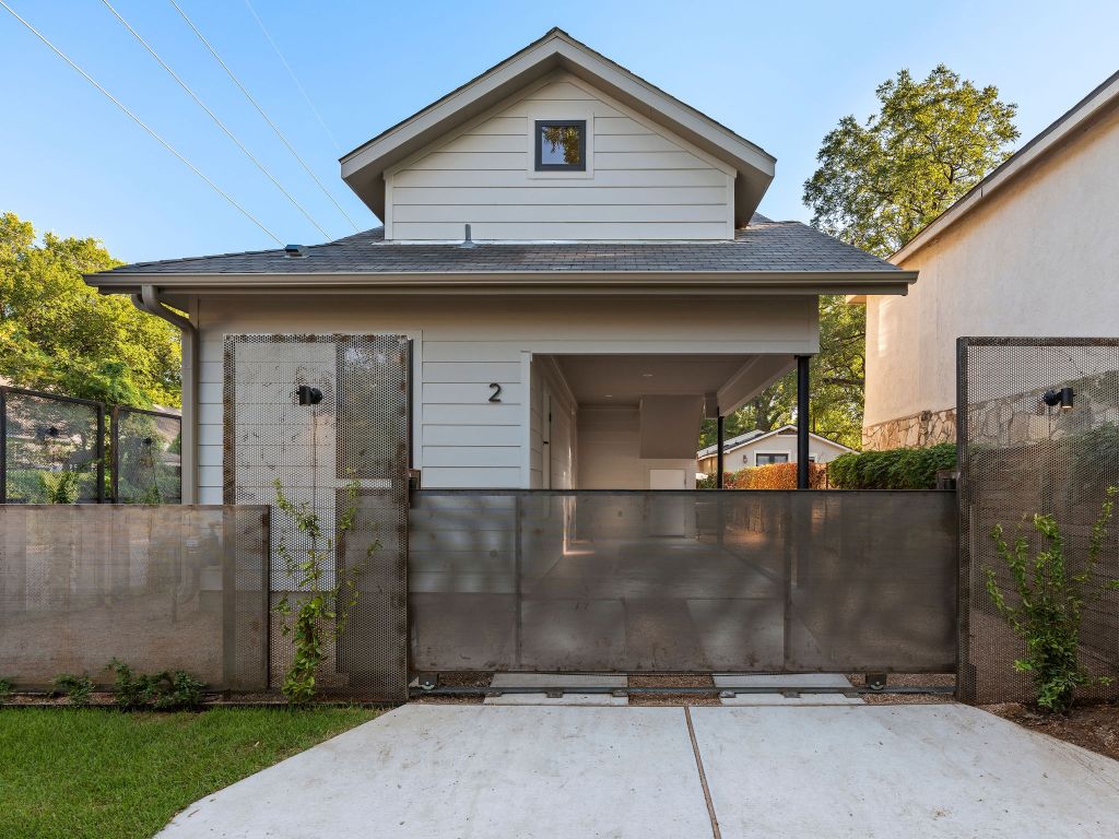 1401 East 3rd Street, Unit 2 Austin, TX 78702 - Photo 7 of 31 View of front facade featuring roof with shingles and a gate
