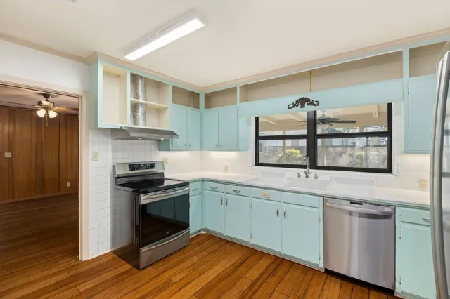 a kitchen with stainless steel appliances granite countertop a stove and a sink