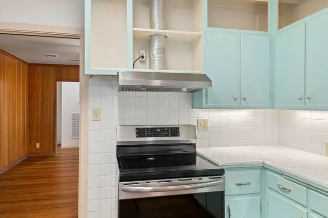 a kitchen with granite countertop a stove and a cabinet