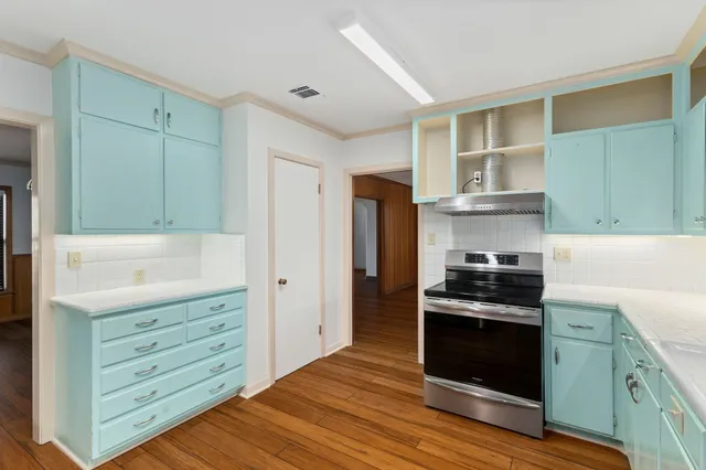 a kitchen with stainless steel appliances a stove and a refrigerator