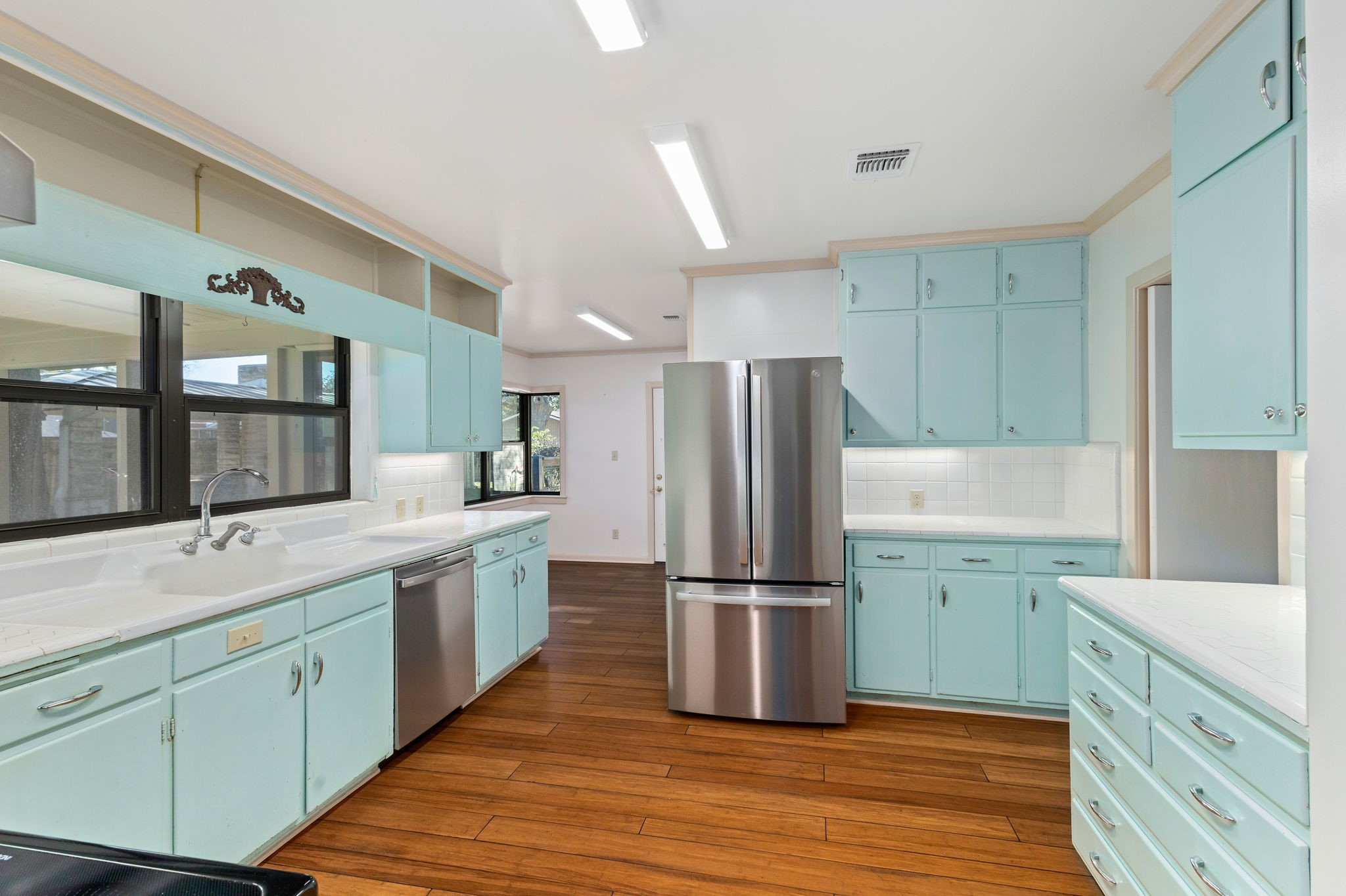 301 Bonham Street Columbus, TX 78934 - Photo 15 of 44 a kitchen with sink a refrigerator and wooden cabinets