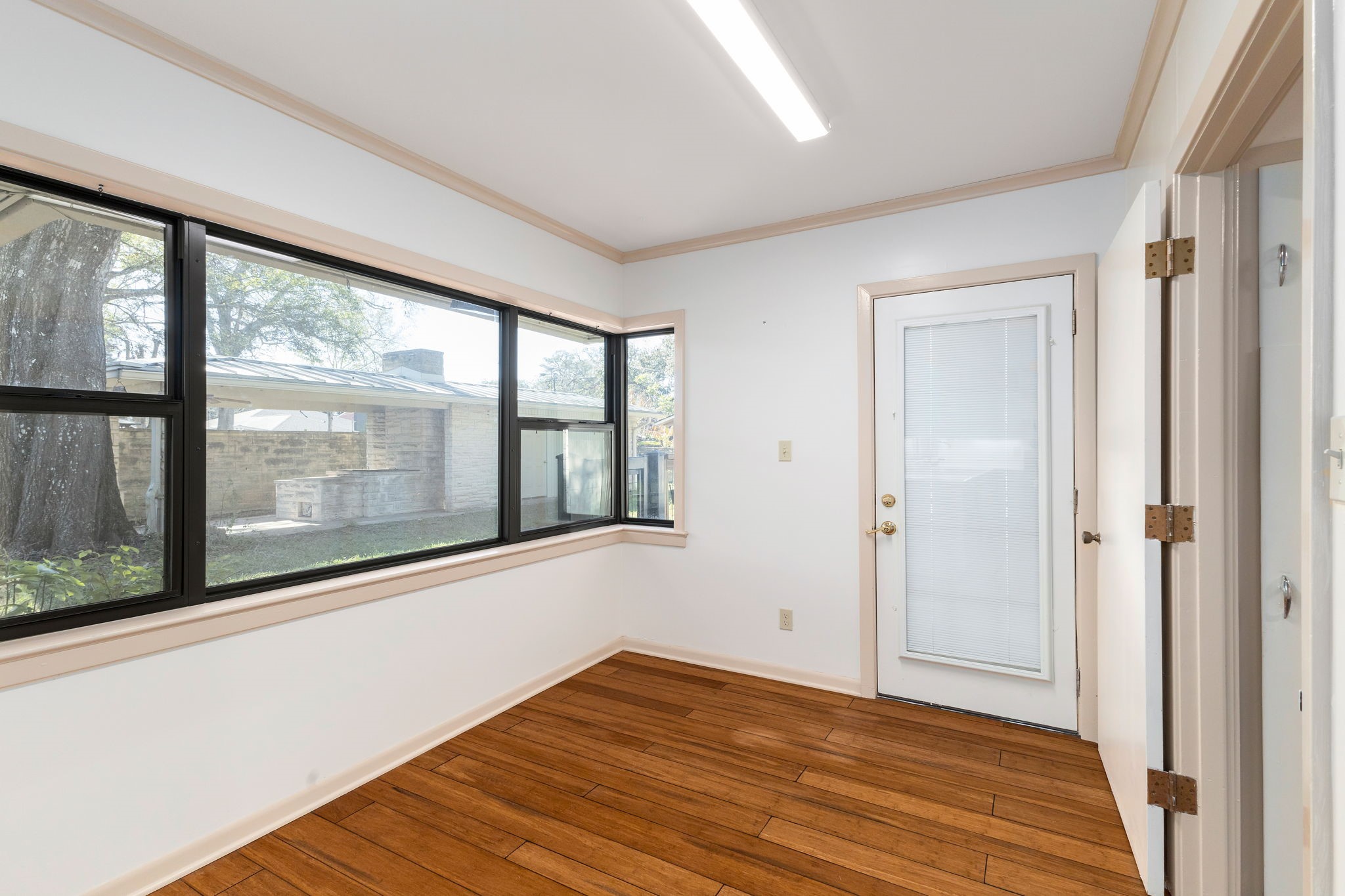 301 Bonham Street Columbus, TX 78934 - Photo 16 of 44 a view of empty room with wooden floor and fan
