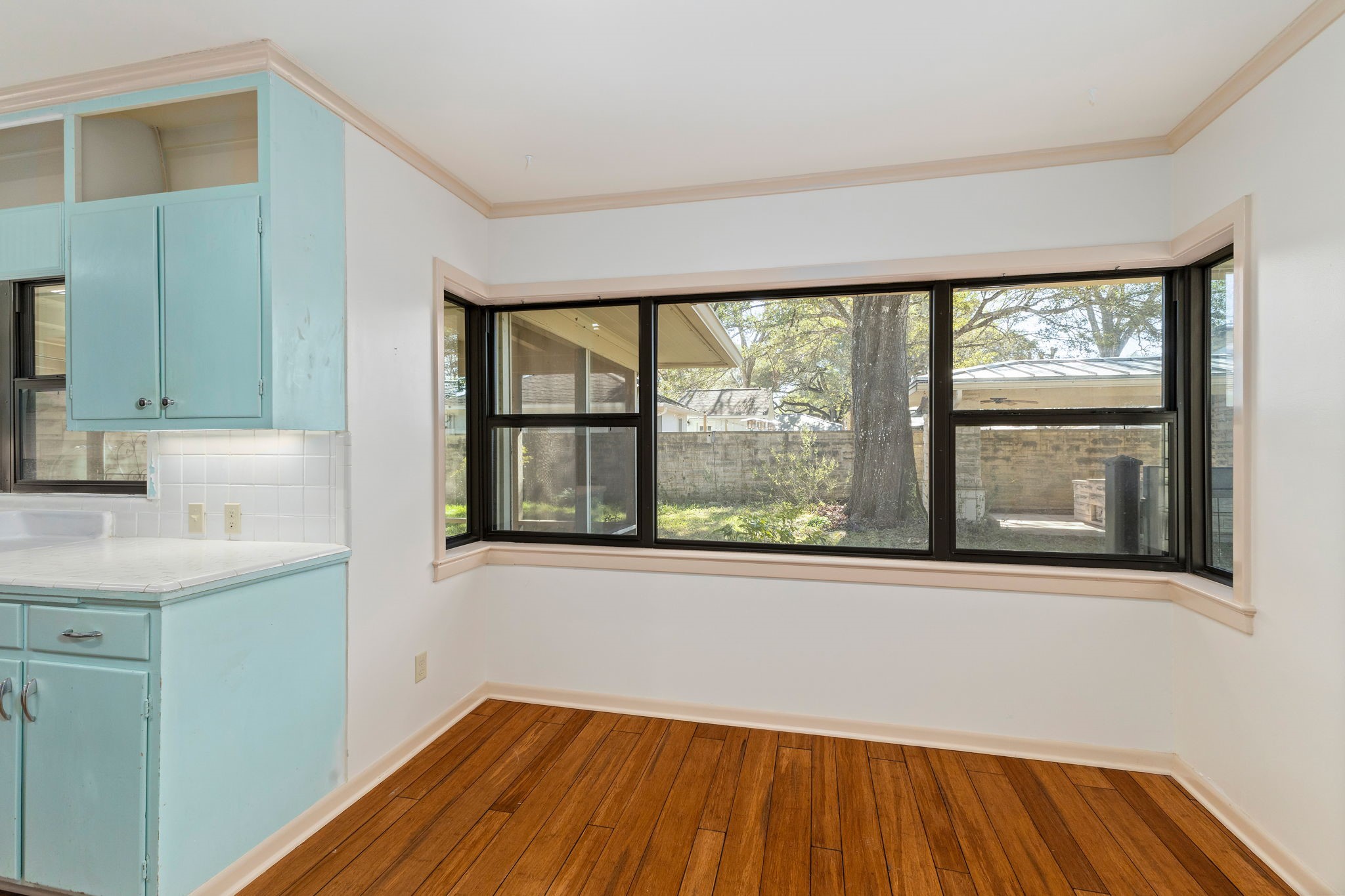 301 Bonham Street Columbus, TX 78934 - Photo 17 of 44 a view of a room that has a window and wooden floor