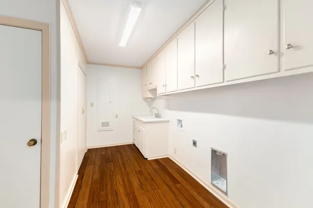 a view of a kitchen with white cabinets
