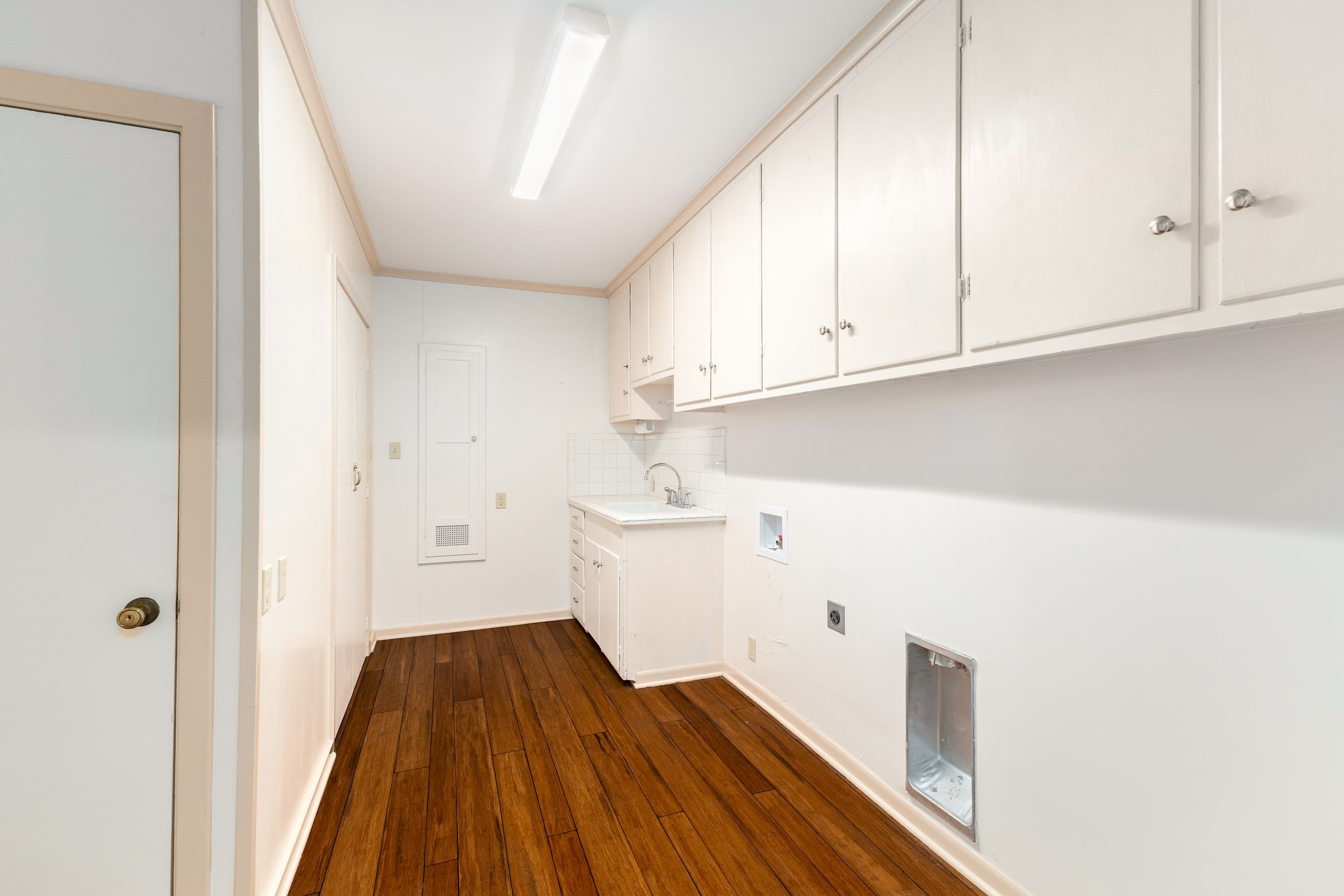 301 Bonham Street Columbus, TX 78934 - Photo 18 of 44 a view of a kitchen with white cabinets