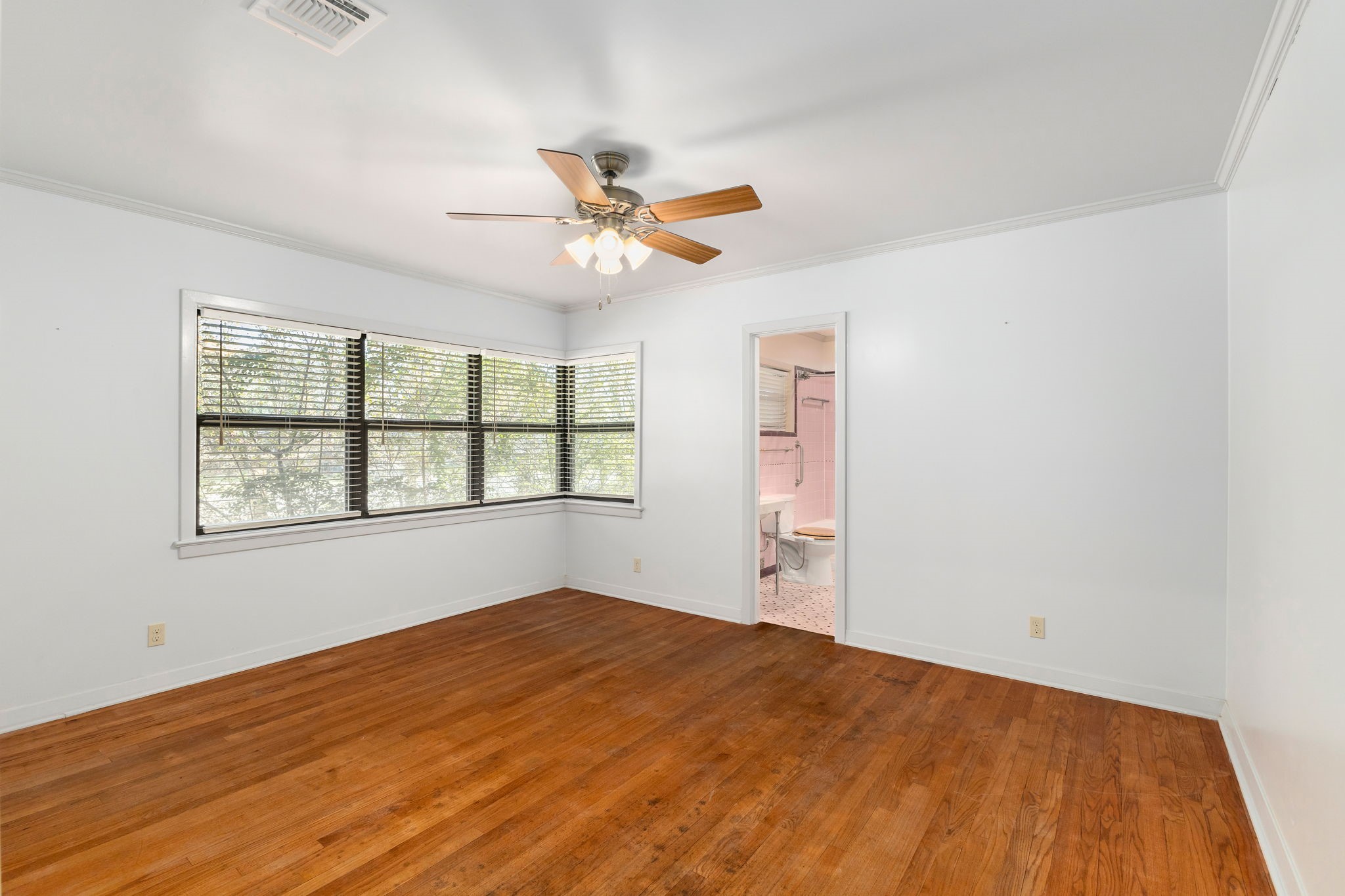 301 Bonham Street Columbus, TX 78934 - Photo 23 of 44 a view of empty room with wooden floor and fan