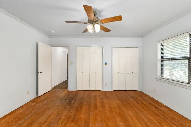 a view of a livingroom with a ceiling fan and wooden floor