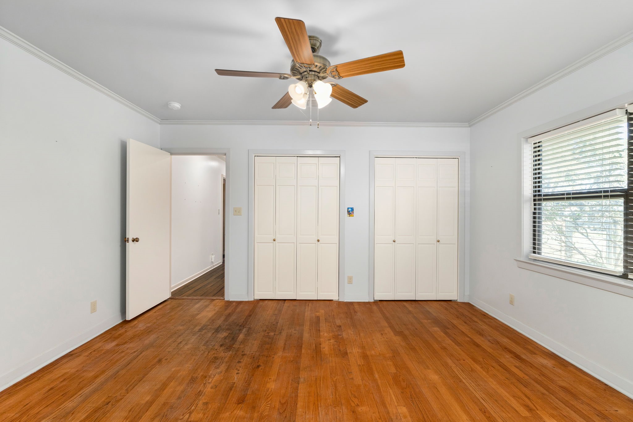 301 Bonham Street Columbus, TX 78934 - Photo 24 of 44 a view of a livingroom with a ceiling fan and wooden floor