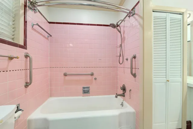 a bathroom with a bathtub and shower