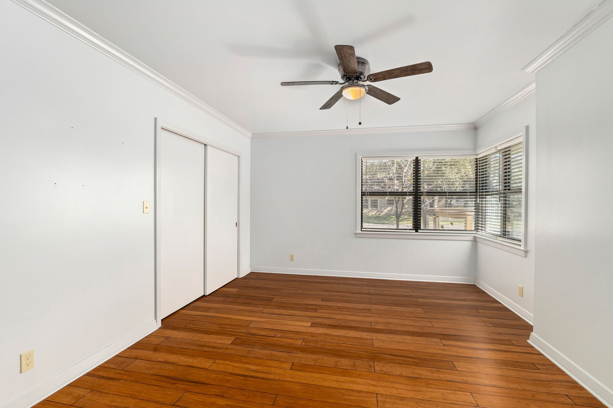 301 Bonham Street Columbus, TX 78934 - Photo 31 of 44 a view of empty room with wooden floor and fan