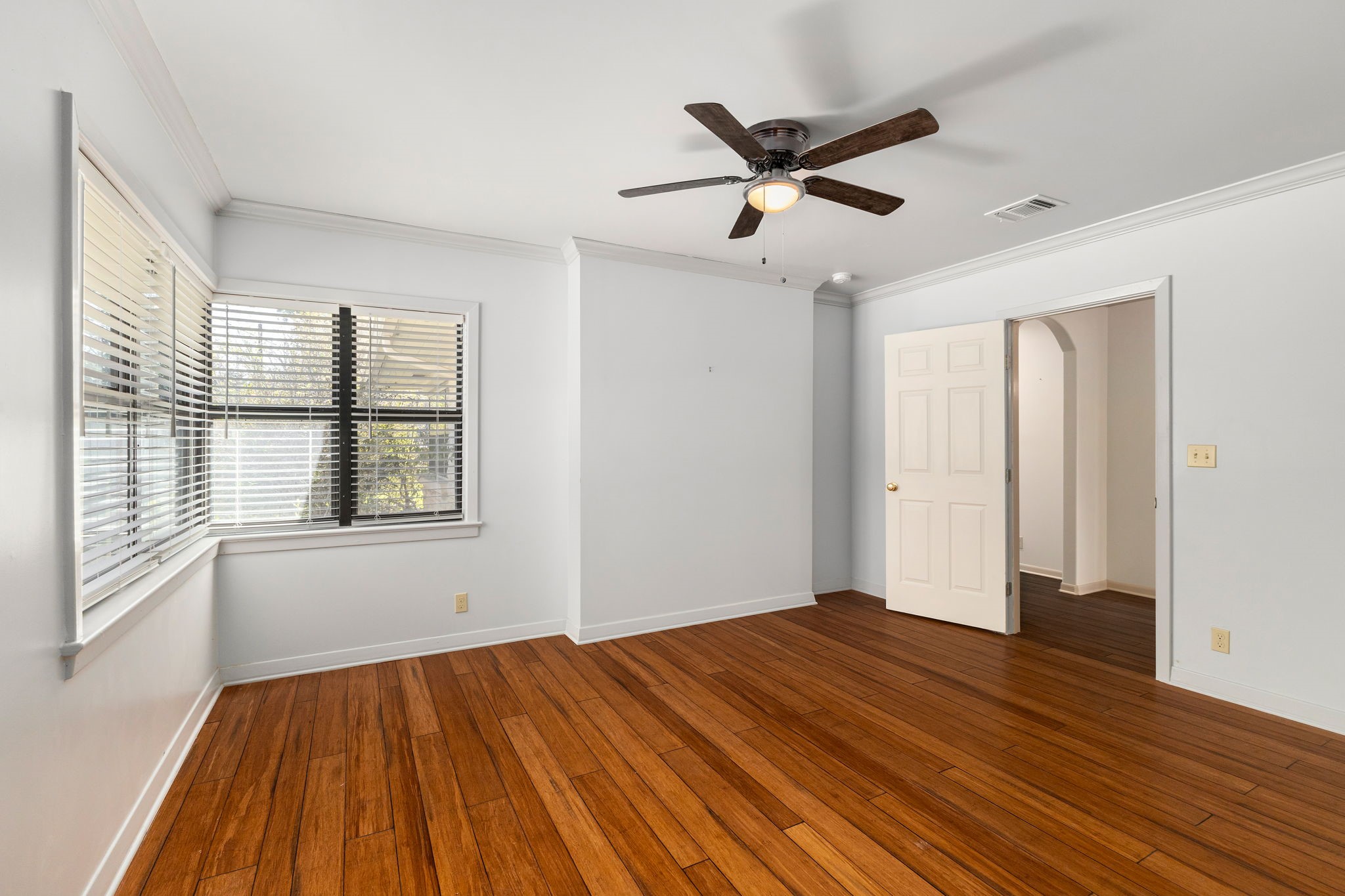 301 Bonham Street Columbus, TX 78934 - Photo 32 of 44 a view of empty room with wooden floor and fan
