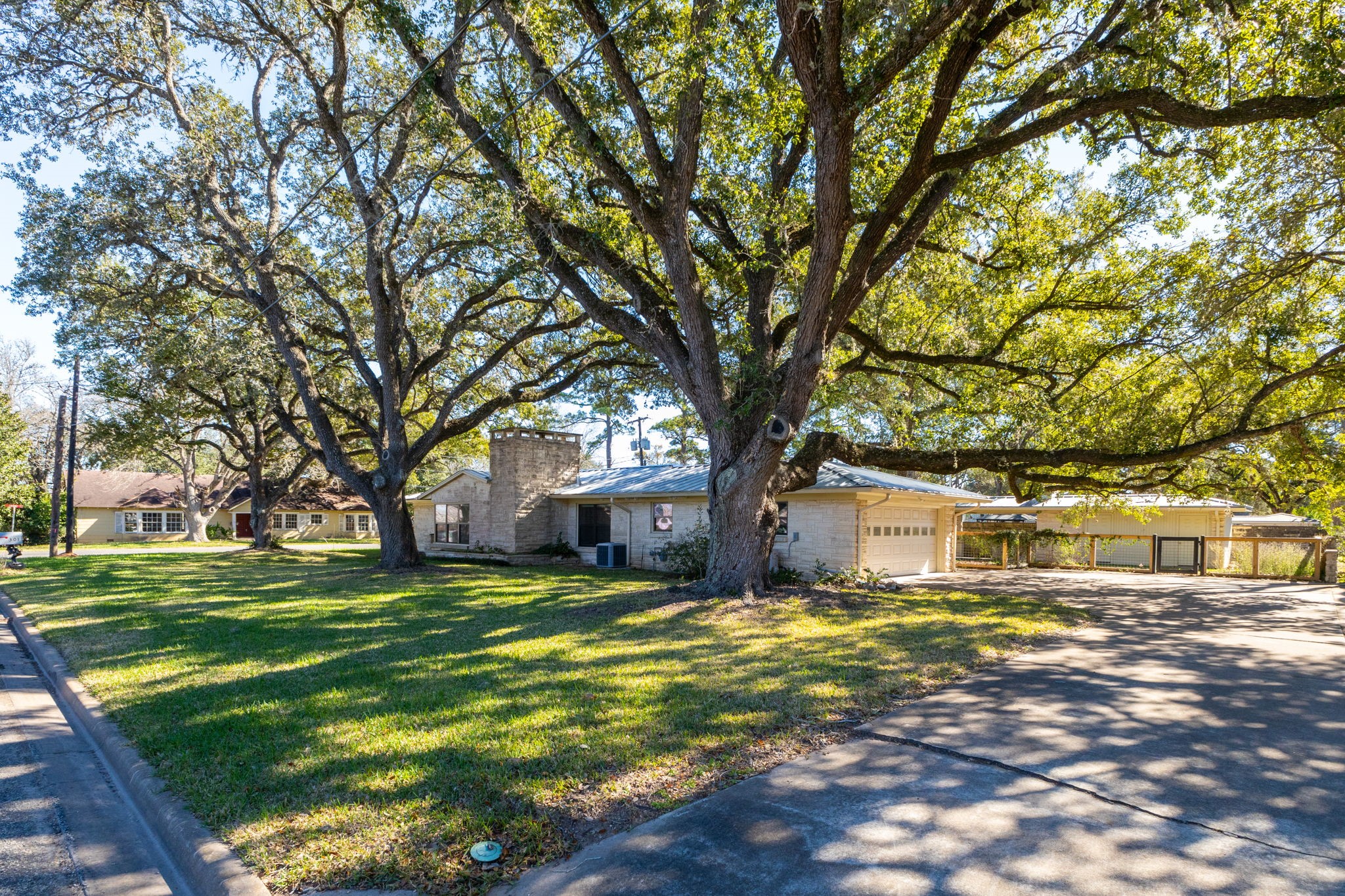301 Bonham Street Columbus, TX 78934 - Photo 41 of 44 a house with trees in front of it