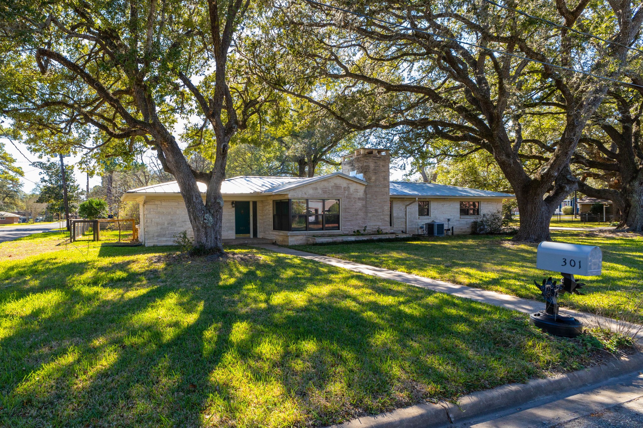 301 Bonham Street Columbus, TX 78934 - Photo 43 of 44 a view of a house with swimming pool and a tree