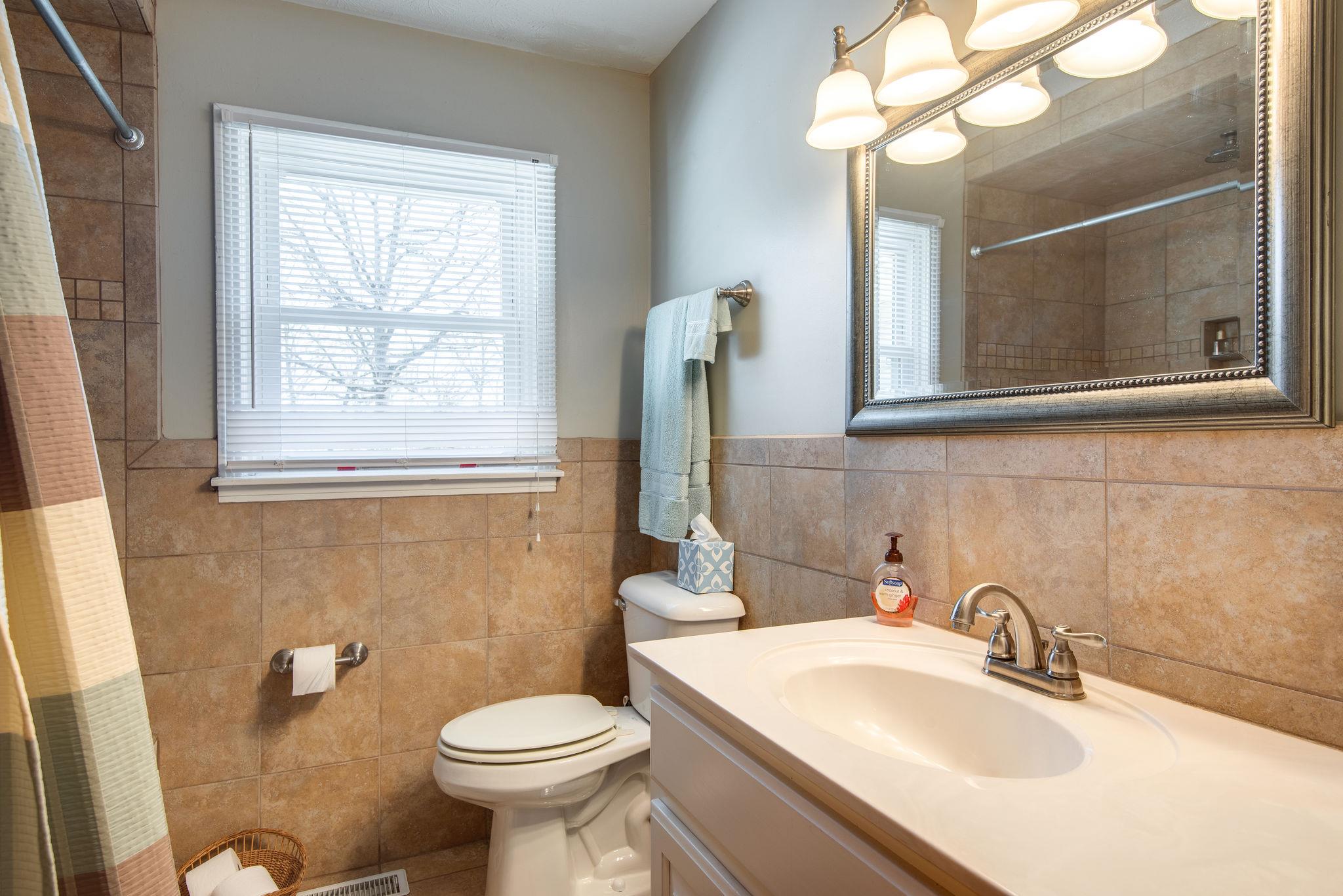128 Robert Porter Road Dickson, TN 37055 - Photo 16 of 27 Guest Bath w/ Tile Flooring & Linen Storage