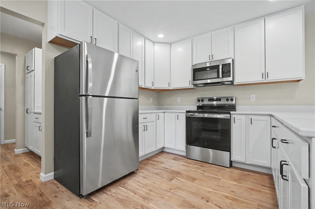 7583 Yale Road Atwater, OH 44201 - Photo 15 of 41 Kitchen comes fully appliance with new energy efficient dishwasher, range, range hood, microwave, and refrigerator.