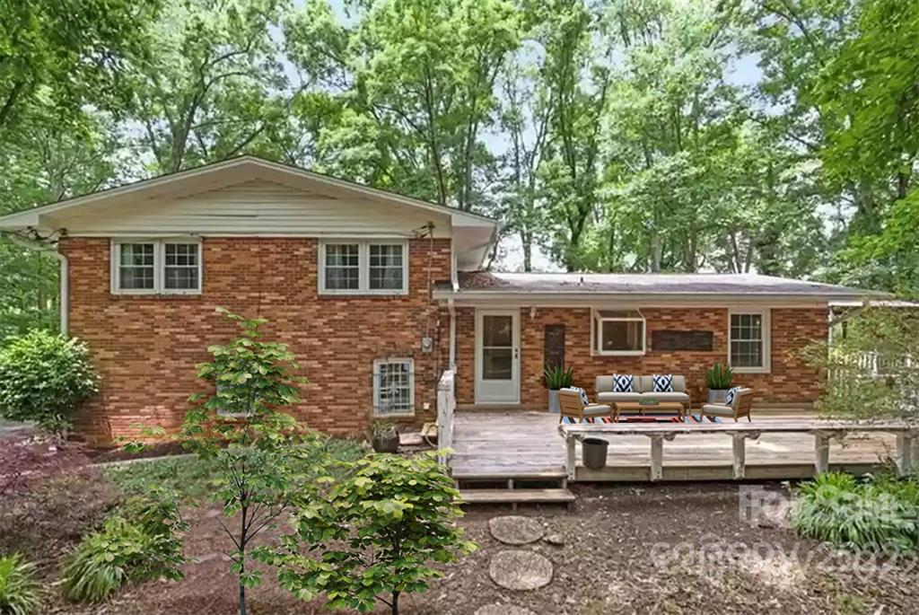 1024 Timber Lake Drive Charlotte, NC 28227 - Photo 5 of 34 a front view of a house with a yard table and chairs