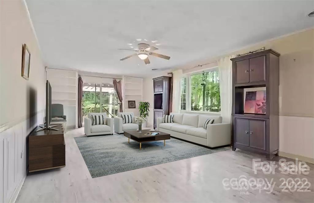 1024 Timber Lake Drive Charlotte, NC 28227 - Photo 10 of 34 a living room with furniture floor to ceiling window and a flat screen tv