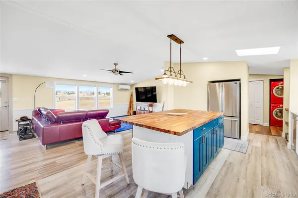 a open kitchen with stainless steel appliances granite countertop a stove and kitchen island