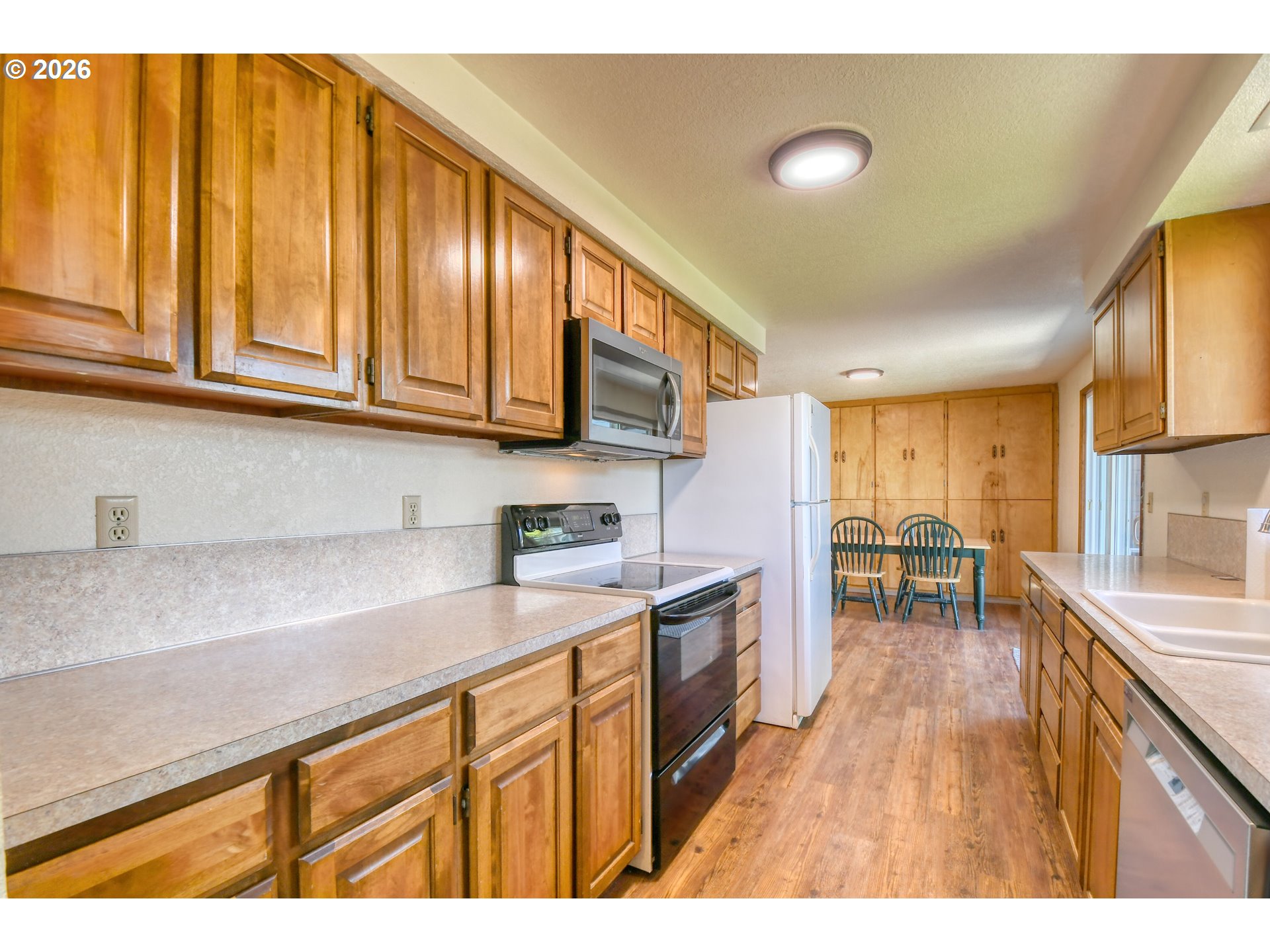 1107 Southwest 23rd Street Pendleton, OR 97801 - Photo 17 of 42 a kitchen with stainless steel appliances granite countertop wooden cabinets a sink and dishwasher