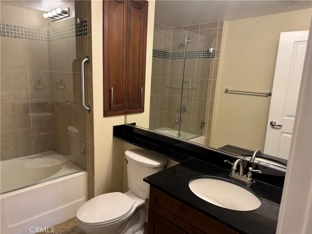 a bathroom with a sink toilet a mirror and shower
