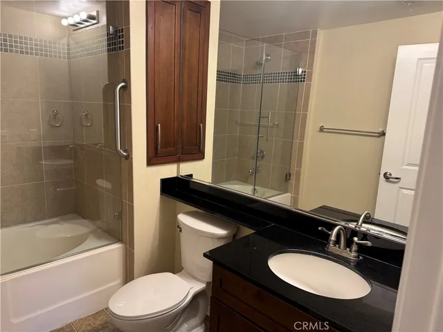 a bathroom with a sink toilet a mirror and shower