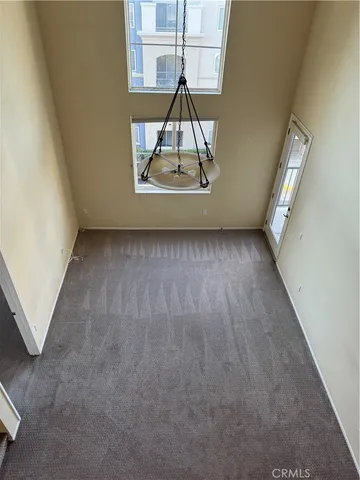 an entryway in wooden floor hall witha front door