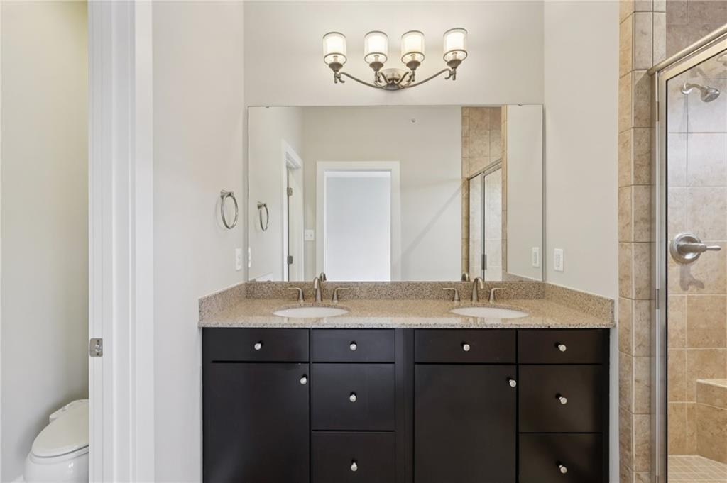 228 Venango Trail Mars, PA 16046 - Photo 17 of 41 a bathroom with a granite countertop sink a mirror and a toilet
