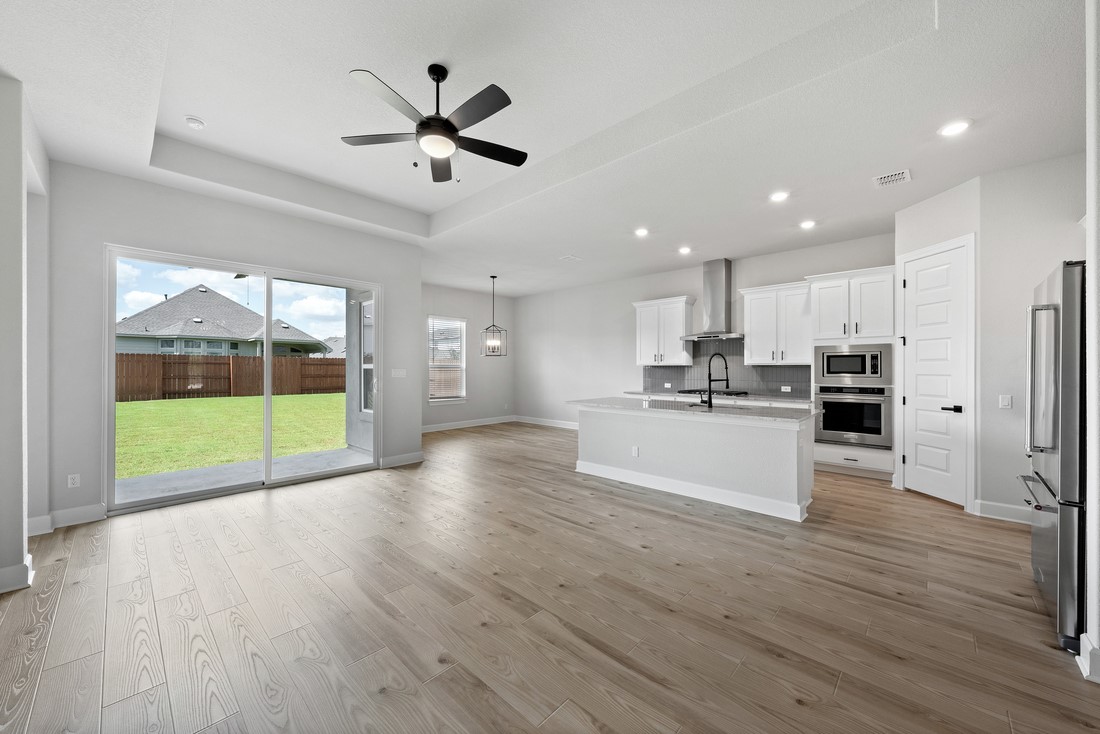 a view of kitchen with cabinets and wooden floor
